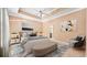 Virtually staged main bedroom with tray ceiling and ensuite bath at 8608 Hopper Ct., Myrtle Beach, SC 29579