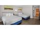Bright bedroom with two double beds and wood-look floors at 9550 Shore Dr. # 1202, Myrtle Beach, SC 29572