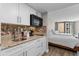 Small kitchen with granite counters and white cabinets at 9550 Shore Dr. # 831, Myrtle Beach, SC 29572