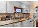 Well-equipped kitchen with granite countertops and white cabinets at 2001 S Ocean Blvd. # 1005, Myrtle Beach, SC 29577