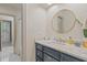 Elegant bathroom with dark vanity, quartz countertop, and a large mirror at 4809 Burchap Dr., Myrtle Beach, SC 29577