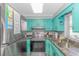 Kitchen with teal cabinets, stainless steel appliances, and granite countertops at 6001-1157 S Kings Hwy., Myrtle Beach, SC 29575