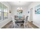 Bright dining room with a round table, four chairs, and large artwork on the wall at 1315 Bermuda Grass Dr., Myrtle Beach, SC 29579