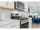 Stainless steel range and microwave in a kitchen with white cabinets at 1315 Bermuda Grass Dr., Myrtle Beach, SC 29579