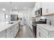 Modern kitchen with white cabinets, stainless steel appliances, and a large island at 1315 Bermuda Grass Dr., Myrtle Beach, SC 29579