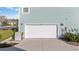 White garage door on a light-blue house with landscaping at 1315 Bermuda Grass Dr., Myrtle Beach, SC 29579