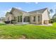 Tan house exterior with large sunroom and nicely landscaped yard at 544 Running Deer Trail, Myrtle Beach, SC 29588