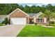 Brick house with two-car garage and lush lawn at 544 Running Deer Trail, Myrtle Beach, SC 29588