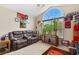 Cozy living room featuring a brown leather couch and large window at 544 Running Deer Trail, Myrtle Beach, SC 29588