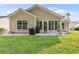 Back exterior view of tan house with sunroom and patio at 544 Running Deer Trail, Myrtle Beach, SC 29588