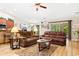 Spacious living room with two leather sofas, hardwood floors, and a view to the kitchen at 544 Running Deer Trail, Myrtle Beach, SC 29588