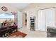 Bright bedroom with large TV, built-in shelving, and double doors at 544 Running Deer Trail, Myrtle Beach, SC 29588