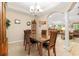 Formal dining room with glass-top table and wood chairs at 544 Running Deer Trail, Myrtle Beach, SC 29588