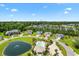 Aerial view of community, showing homes, pond, and pool at 544 Running Deer Trail, Myrtle Beach, SC 29588