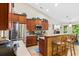 Kitchen with breakfast bar, stainless steel appliances, and wood cabinets at 544 Running Deer Trail, Myrtle Beach, SC 29588