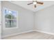 Empty bedroom with ceiling fan, light wood-look floors, and a window with a view at 1727 Cane Branch Rd., Loris, SC 29569