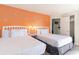 Bright bedroom with two twin beds and an orange accent wall at 2300 N Ocean Blvd. # 339/340, Myrtle Beach, SC 29577