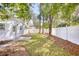 Landscaped backyard with a white fence at 615 1St Ave. N, Surfside Beach, SC 29575