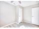 Spacious bedroom with ceiling fan, wood-look floors, and two closets at 615 1St Ave. N, Surfside Beach, SC 29575
