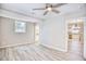 Spacious bedroom with hardwood floors and ceiling fan, open to kitchen at 615 1St Ave. N, Surfside Beach, SC 29575