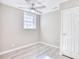 Bright bedroom with ceiling fan, wood-look flooring, and ample closet space at 615 1St Ave. N, Surfside Beach, SC 29575