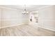 Bright dining room with hardwood floors and chandelier, open to kitchen at 615 1St Ave. N, Surfside Beach, SC 29575