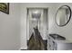 Bright hallway with dark hardwood floors and a decorative console table at 839 St. Albans Loop, Conway, SC 29526