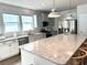 Modern kitchen with stainless steel appliances and an expansive granite island at 240 Goose Pond Dr., Myrtle Beach, SC 29579