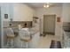 Bright eat-in kitchen with white cabinets, tile floor, and island at 9606 Indigo Creek Blvd., Murrells Inlet, SC 29576