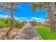 Wooden walkway to the beach with lush landscaping at 7100 N Ocean Blvd. # 218, Myrtle Beach, SC 29572