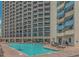 Large outdoor pool with plenty of lounge chairs at 7100 N Ocean Blvd. # 218, Myrtle Beach, SC 29572