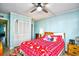 Bedroom with a red snowflake comforter, ceiling fan, and access to a balcony at 4305 S Ocean Blvd. # 205, North Myrtle Beach, SC 29582