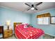 Bedroom with a red snowflake comforter and ceiling fan at 4305 S Ocean Blvd. # 205, North Myrtle Beach, SC 29582