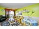 Living room with lime walls, tan couch, and dining area at 4305 S Ocean Blvd. # 205, North Myrtle Beach, SC 29582