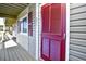 Exterior hallway with red door and wood floors at 4305 S Ocean Blvd. # 205, North Myrtle Beach, SC 29582