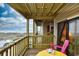 Relaxing balcony with ocean view and yellow table at 4305 S Ocean Blvd. # 205, North Myrtle Beach, SC 29582