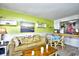 Open concept living and dining area with lime walls at 4305 S Ocean Blvd. # 205, North Myrtle Beach, SC 29582