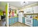 Quaint kitchen with teal cabinets, white appliances, and ample counter space at 4305 S Ocean Blvd. # 205, North Myrtle Beach, SC 29582