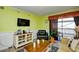 Living room with lime walls, TV, and comfy seating at 4305 S Ocean Blvd. # 205, North Myrtle Beach, SC 29582
