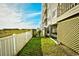 Building exterior with grassy area and white fence at 4305 S Ocean Blvd. # 205, North Myrtle Beach, SC 29582
