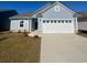 Newly built home with two-car garage and landscaping at 293 Hawks Run Dr., Calabash, NC 28467