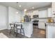 Modern kitchen with white cabinets, granite countertops, and stainless steel appliances at 3519 Cornflower Way, Conway, SC 29526