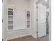 Convenient laundry area with built-in shelving and a bench at 3519 Cornflower Way, Conway, SC 29526