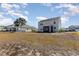 Backyard view showcasing a two-story home with a screened porch at 3519 Cornflower Way, Conway, SC 29526