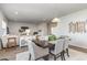 Dining area with a dark wood table and gray upholstered chairs, adjacent to the living room at 3519 Cornflower Way, Conway, SC 29526