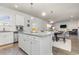 Open concept kitchen boasts white cabinets, granite countertops, and an island with seating at 3519 Cornflower Way, Conway, SC 29526