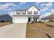 Two-story house with white exterior, landscaping, and a two-car garage at 3519 Cornflower Way, Conway, SC 29526