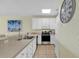 Modern kitchen with stainless steel appliances and white cabinets at 912-B S Ocean Blvd., Surfside Beach, SC 29575