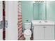 Small bathroom with toilet, sink, and striped shower curtain at 912-B S Ocean Blvd., Surfside Beach, SC 29575