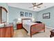Cozy bedroom with a wooden bed frame and ceiling fan at 912-B S Ocean Blvd., Surfside Beach, SC 29575